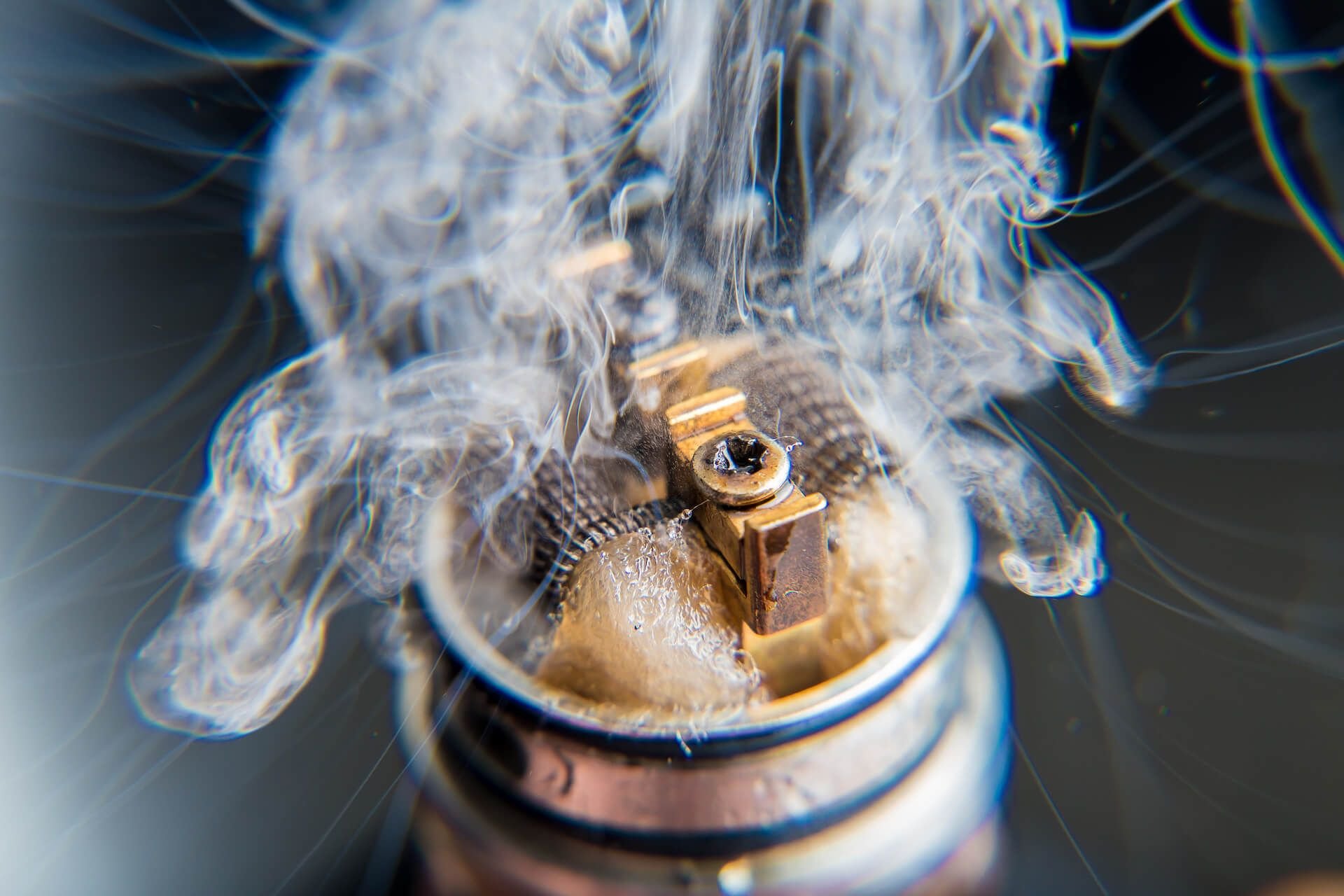 Vaporizer and coil with vape cloud - close up